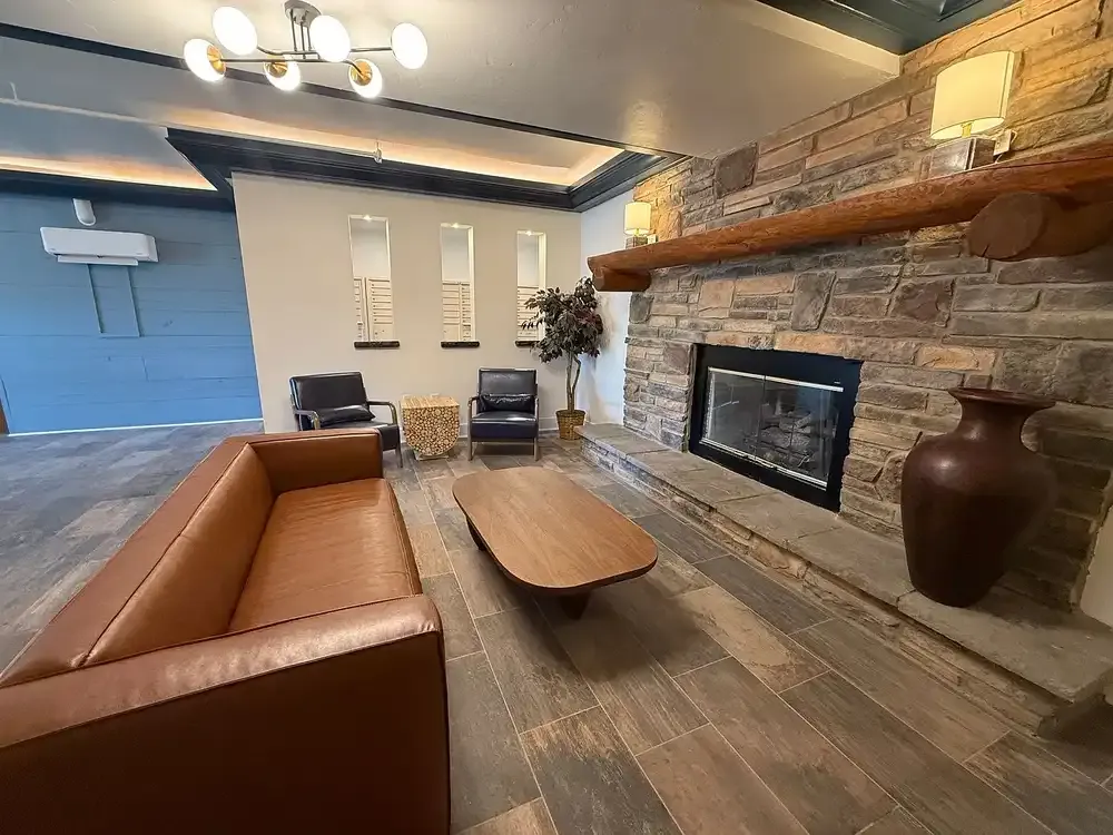 Outdoor swimming pool with mountain backdrop at Storm Peak Apartments